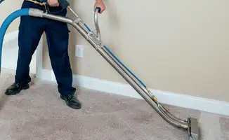 Professional operating a liquid removal machine on a carpeted floor in Columbus, OH